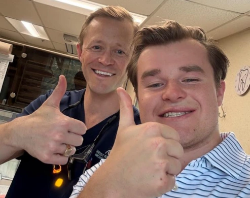 Dentist and patient smiling together at West Towson Dental in Towson, MD.